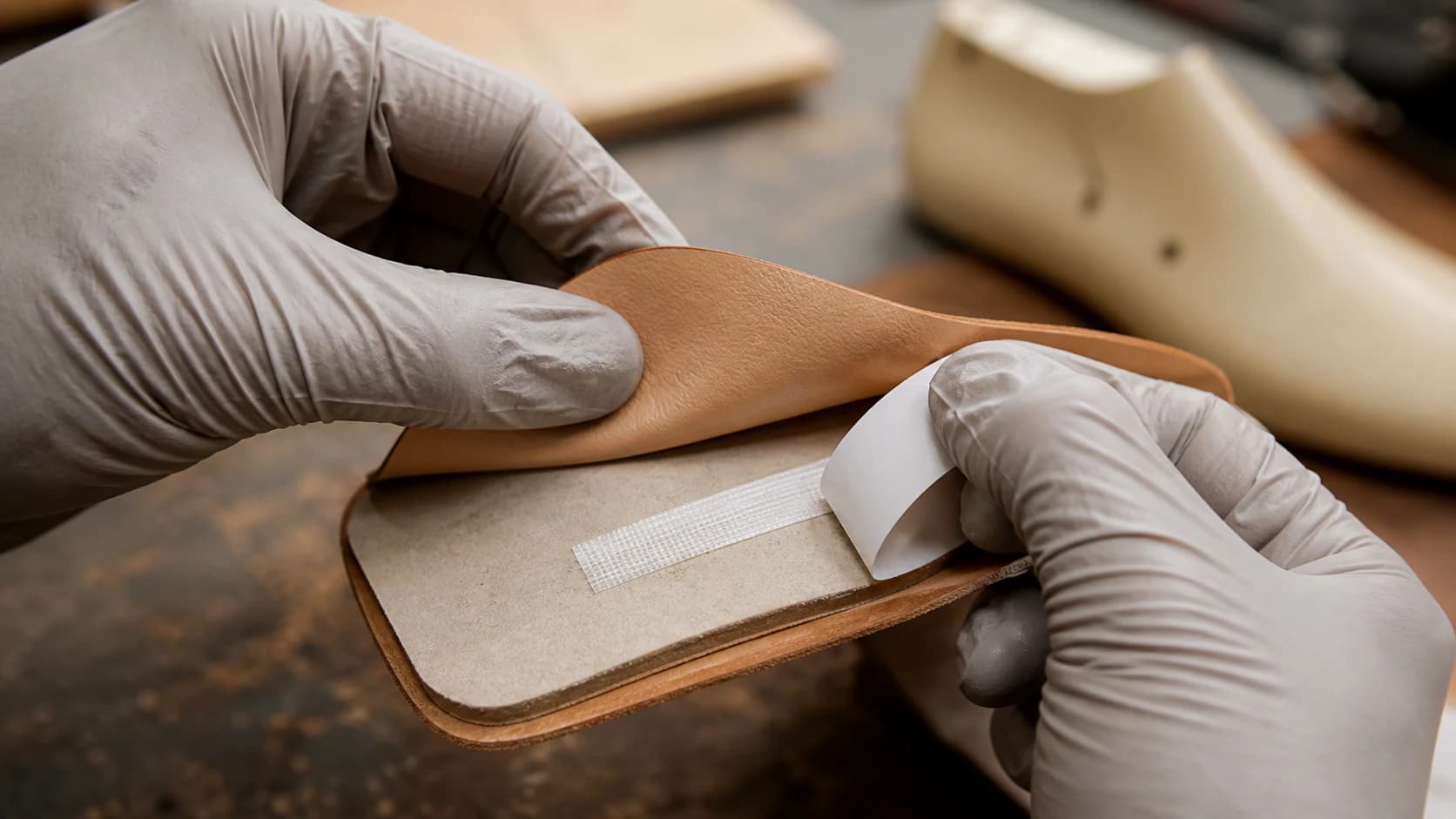 Illustrative positioning of a leather component with textile-reinforced tape